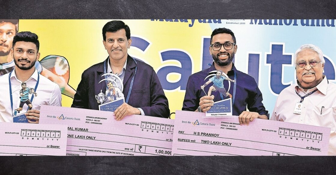 Malayala Manorama Editor Philip Mathew presenting the prize money to M R Arjun, coach U Vimalkumar and H S Pranoy, who were part of the Thomas Cup squad that won the tournament recently. PHOTO: Manorama