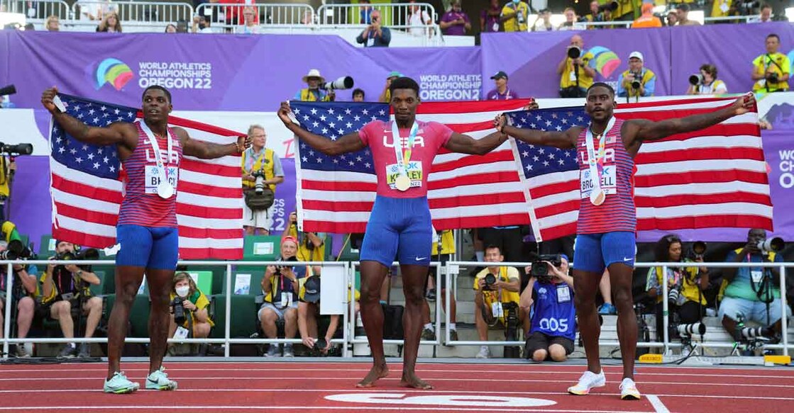 Gold medallist Fred Kerley of the U.S. celebrates after winning the men's 100 metres final alongside silver medallist Marvin Bracy of the U.S. and bronze medallist Trayvon Bromell of the U.S. REUTERS/Aleksandra Szmigiel