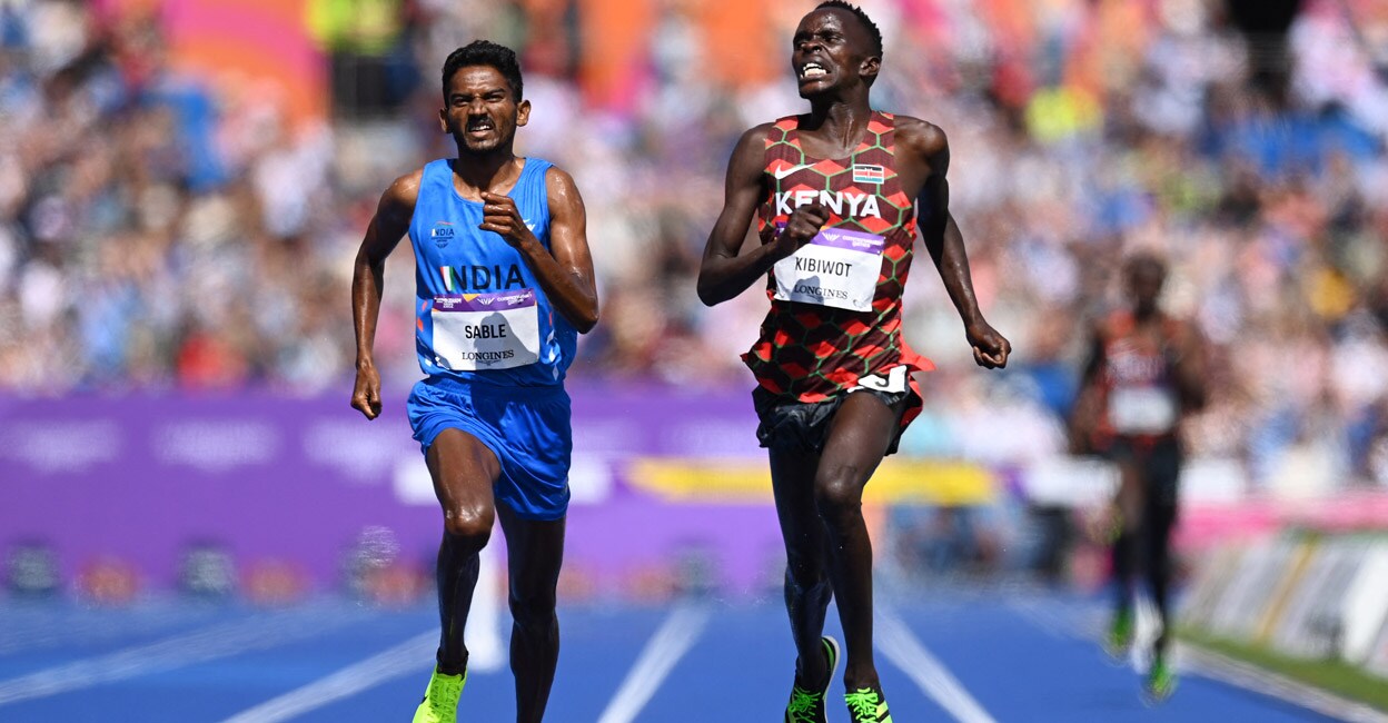 Kenya's Abraham Kibiwot crosses the finish line  ahead of Avinash Sable. Photo: AFP/Glyn Kirk