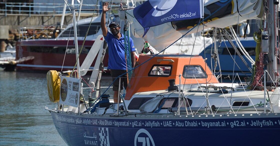 Abhilash Tomy waves aboard his monohull Bayanat as he leaves Les Sables-d’Olonne at the start of the Golden Globe Race. Photo: AFP/Sebastien Salom-Gomis