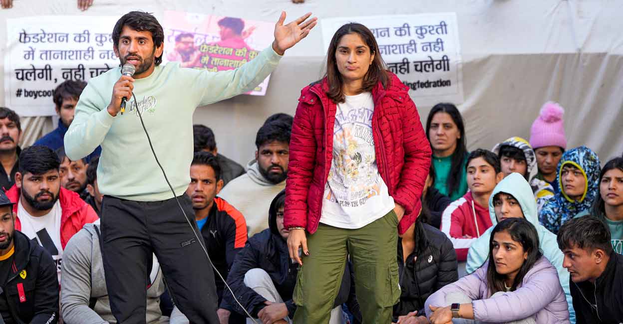 Wrestler Bajrang Punia speaks as fellow wrestler Vinesh Phogat looks on during their ongoing protest against the Wrestling Federation of India (WFI), at Jantar Mantar in New Delhi on Friday. Photo: PTI