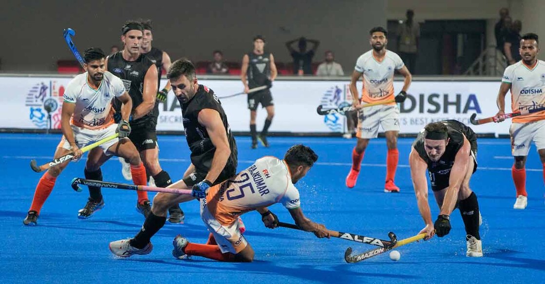 India and New Zealand players vie for the ball during the 2023 Men's FIH Hockey World Cup match in Bhubaneswar on Sunday. Photo: PTI