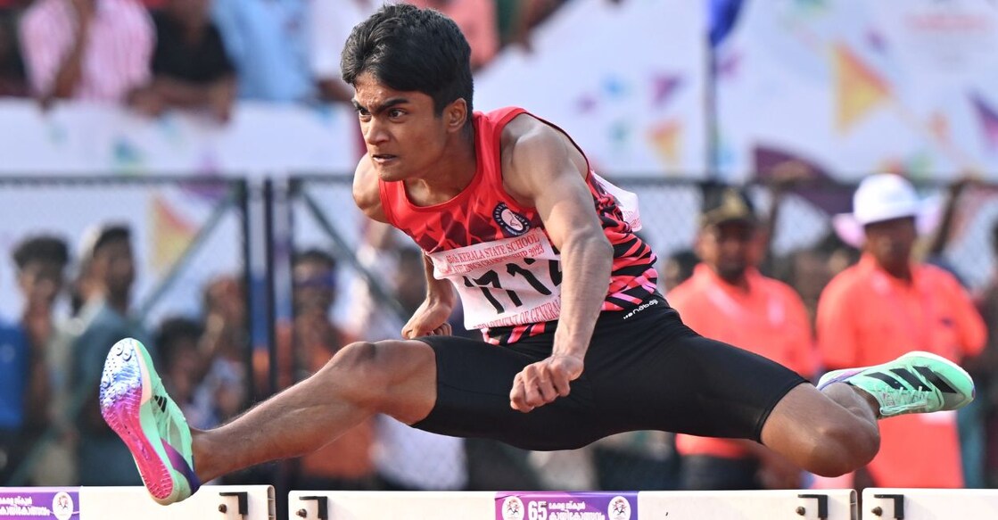 Kiran K of Palakkad en route to his gold in junior boys' 110 m hurdles. Photo: Manorama