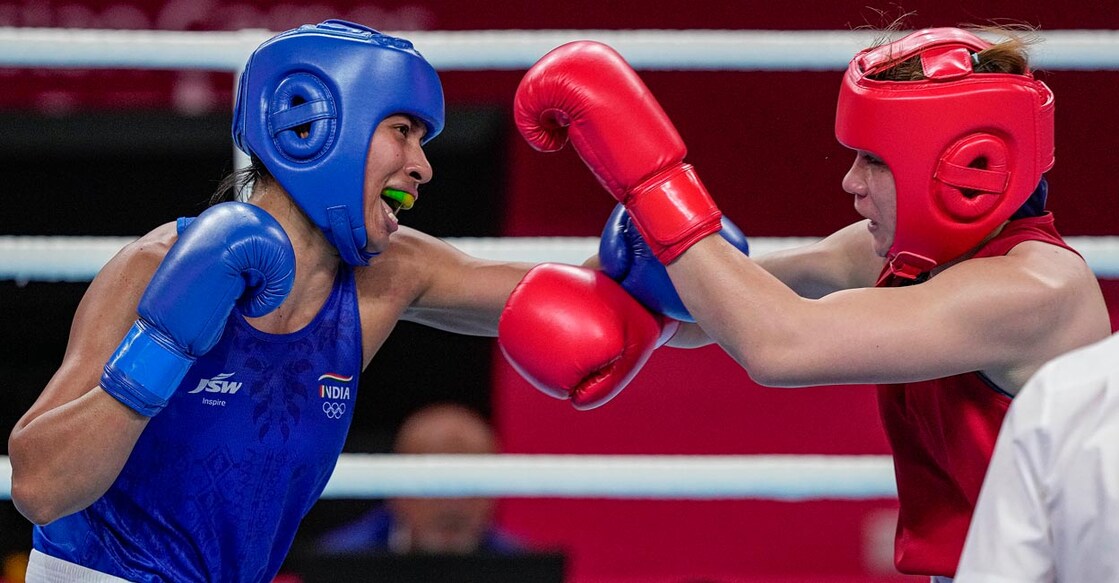 Lovlina Borgohain, left, and Thailand's Baison Maneekon in action. Photo: PTI/Gurinder Osan