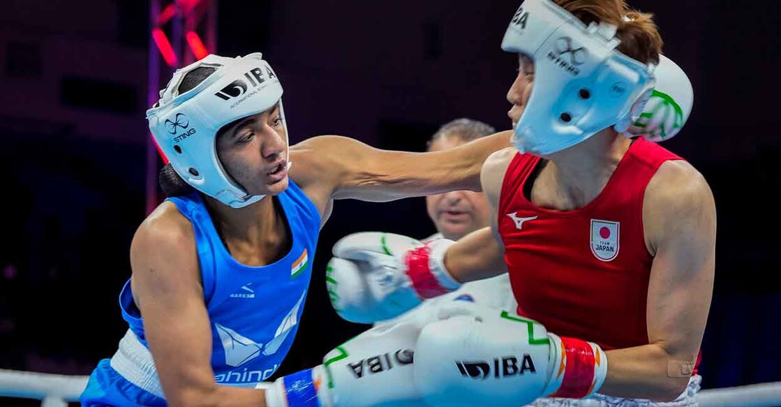 Nitu lands a punch on Madoka Wada. Photo: PTI/Gurinder Osan