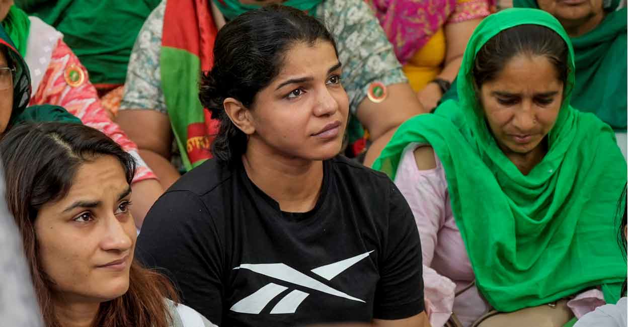 Wrestlers Vinesh Phogat and Sakshi Malik with supporters during the protest at Jantar Mantar in New Delhi on Thursday. Photo: PTI/Vijay Verma