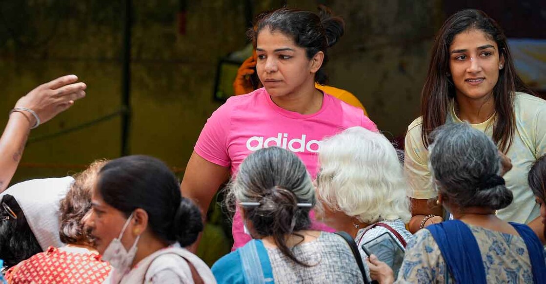 Wrestlers Sakshi Malik and Sangita Phogat interact with the supporters during the protest at Jantar Mantar on Saturday. Photo: PTI/Vijay Verma