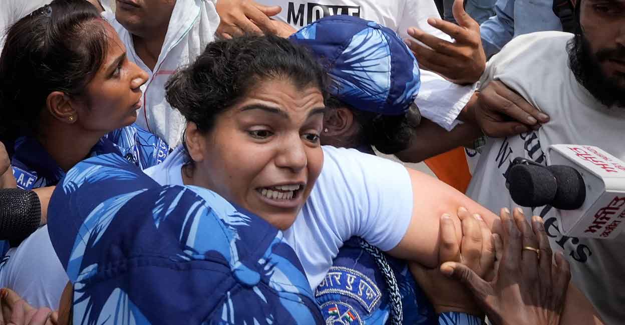 PTI05_28_2023_000121A Security personnel detain wrestler Sakshi Malik. Photo: PTI/Kamal Singh