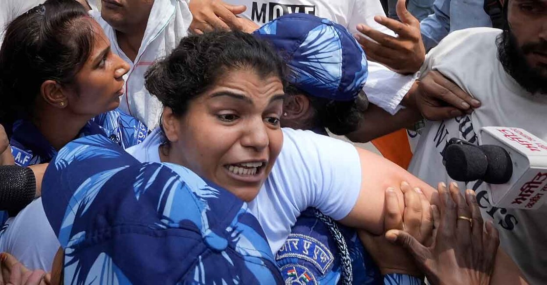 Security personnel detain wrestler Sakshi Malik. Photo: PTI/Kamal Singh
