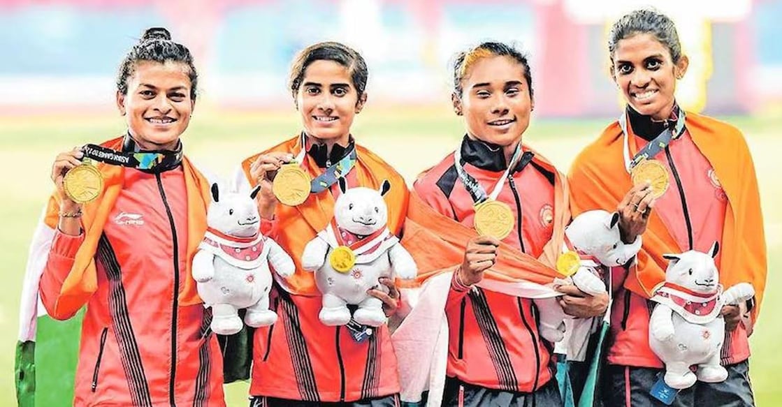 From left: Saritaben Laxmanbhai Gayakwad, V K Vismaya, Hima Das and M R Poovamma on the podium after winning the 4x400m relay gold at the 2018 Asian Games. File photo.