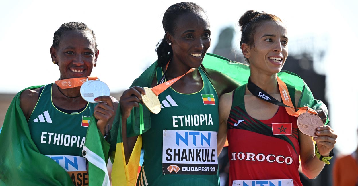 Amane Beriso flanked by silver medallist Gotytom Gebreslase, left, and bronze medallist Fatima Ezzahra Gardadi. Photo: Reuters/Dylan Martinez
