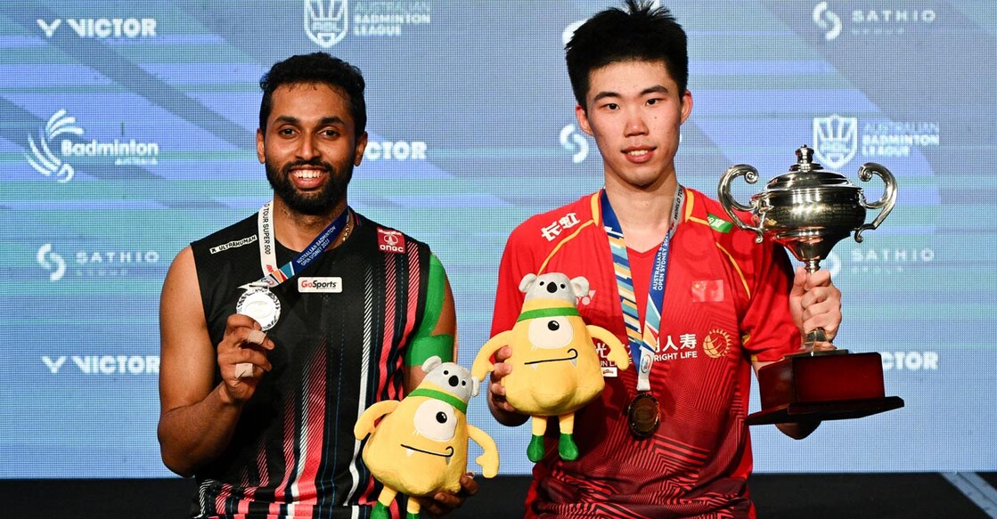 H S Prannoy and Weng Hong Yang pose with the medals and trophy. Photo: AFP/Izhar Khan 
