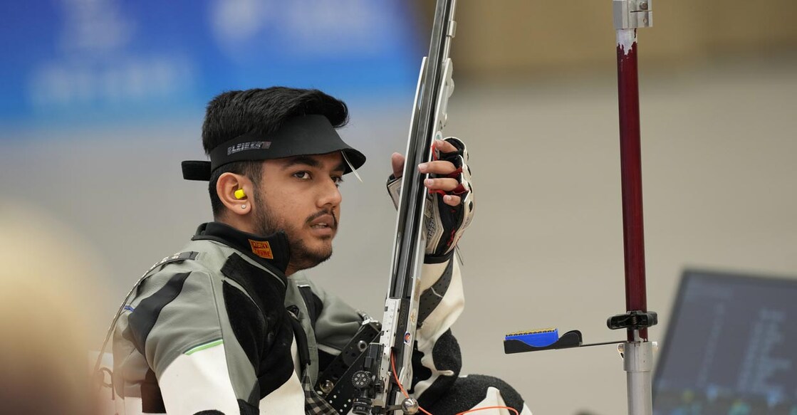 Aishwary Pratap Singh Tomar competes in the finals of men's 50m rifle 3 positions event. Photo: PTI/Shailendra Bhojak