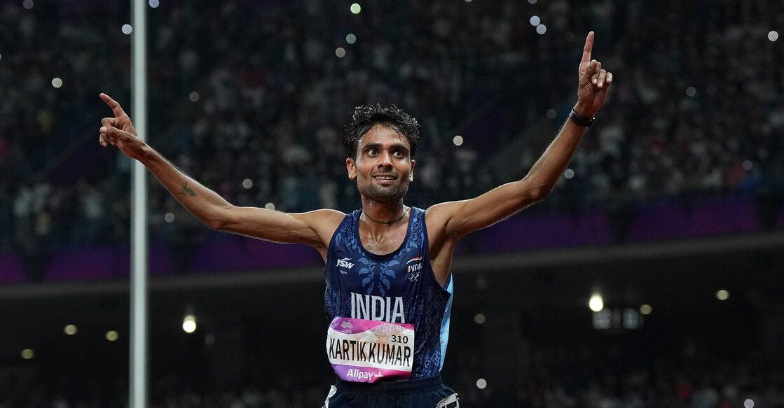 Kartik Kumar celebrates as he crosses the finishing line. Photo: PTI/Shailendra Bhojak