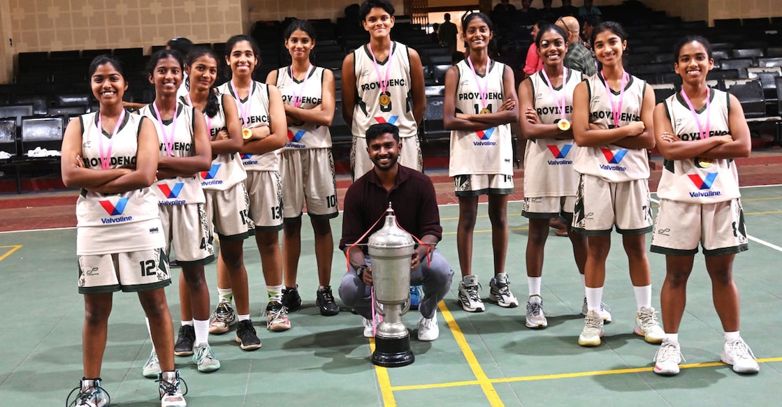 providence-kozhikode-don-bosco-basketball Players and coach of Providence GHSS pose with the trophy. Photo: Special arrangement