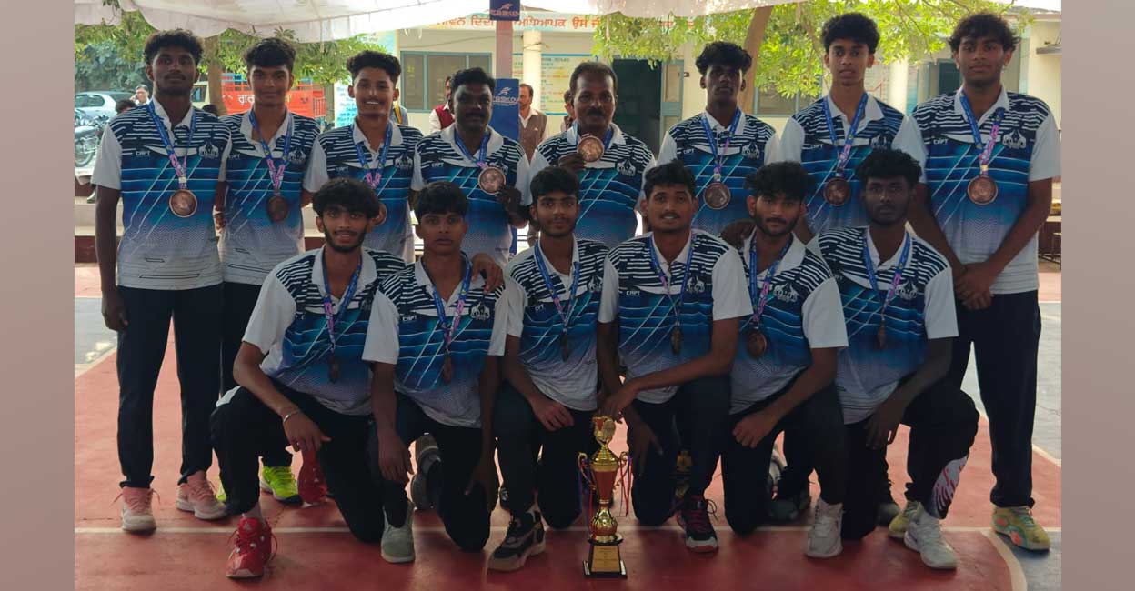 The Kerala team poses with their trophy after finishing third in National School Games basketball in Patiala. Photo: Special arrangement