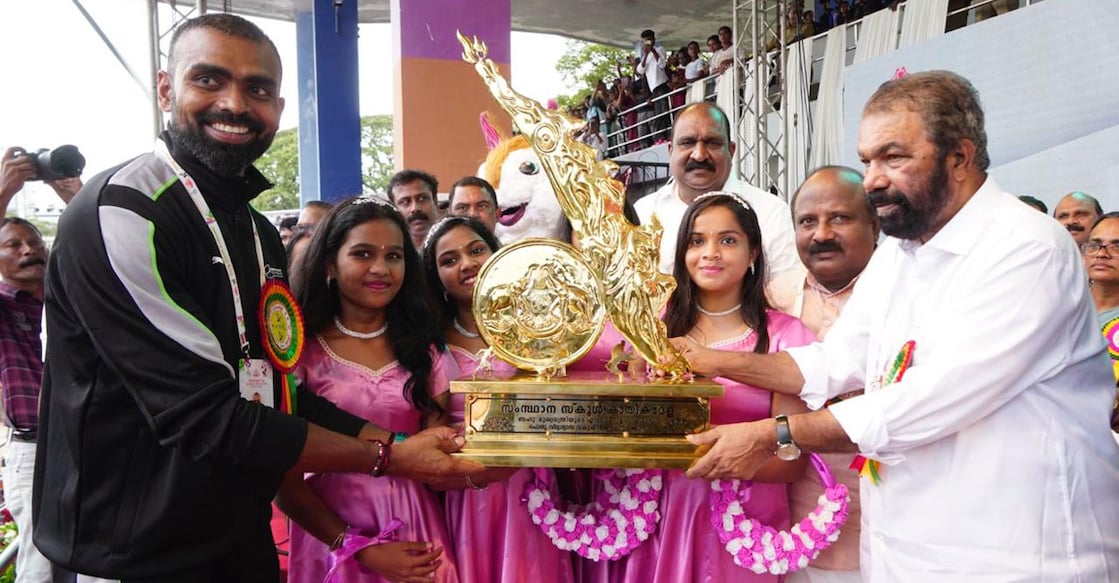 Olympic medallist P R Sreejesh hands over the overall trophy of Kerala School Sports to Kerala's General Education Minister V Sivankutty at the Maharaja's College Ground in Kochi on Mondy. Photo: Special arrangement
