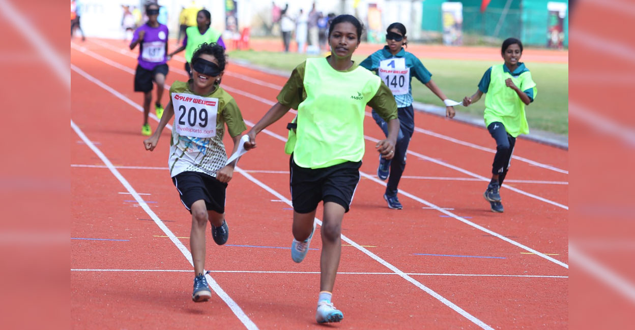 assisted-running-inclusive-sports Blind athletes compete in 100 m race assisted by guide runners at the Inclusive Sports event held as part of Kerala School Games at the Maharaja's College Ground in Kochi on November 5, 2024. Photo: Special arrangement