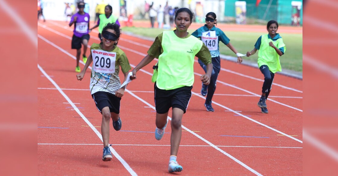 Blind athletes compete in 100 m race assisted by guide runners at the Inclusive Sports event held as part of Kerala School Games at the Maharaja's College Ground in Kochi on November 5, 2024. Photo: Special arrangement 