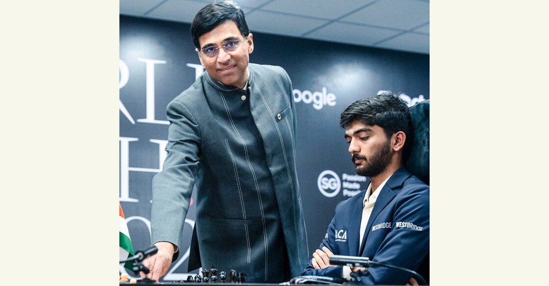 Viswanathan Anand makes the ceremonial first move for D Gukesh during a game in the World Chess Championship in Singapore. File photo: PTI