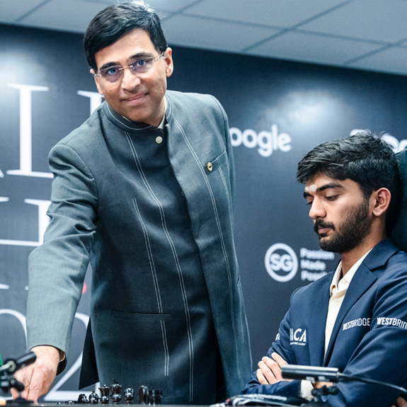 Viswanathan Anand makes the ceremonial first move for D Gukesh during a game in the World Chess Championship in Singapore. File photo: PTI