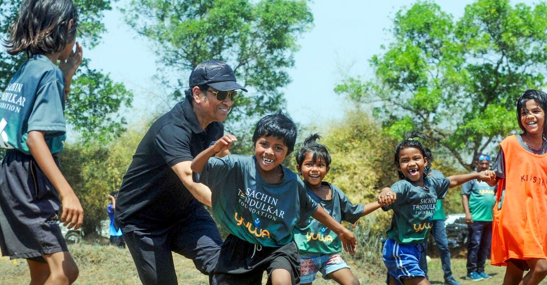 Sachin Tendulkar plays with with girl footballers of Yuwa Foundation in Ranchi. Photo: PTI 
