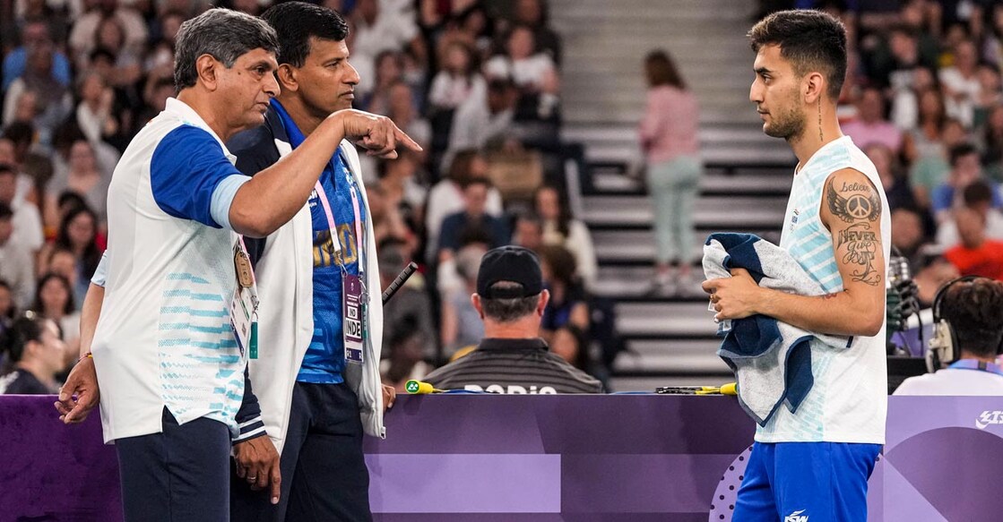 Lakshya Sen is all ears as Prakash Padukone and Vimal Kumar offer tips. Photo: PTI/Ravi Choudhary