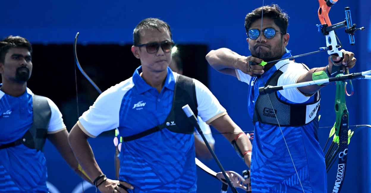 India's Pravin Ramesh Jadhav, India's Tarundeep Rai and India's Dhiraj Bommadevara compete in the archery men's team quarterfinal during the Paris 2024 Olympic Games at the Esplanade des Invalides in Paris on July 29, 2024. Photo: AFP/ Punit Paranjpe
