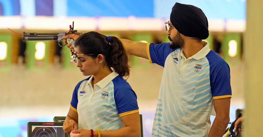 India's Manu Bhaker, left, and teammate Sarabjot Singh compete in the 10m air pistol mixed team qualification round at the 2024 Summer Olympics, Monday, July 29, 2024, in Chateauroux, France. (AP Photo/Manish Swarup)