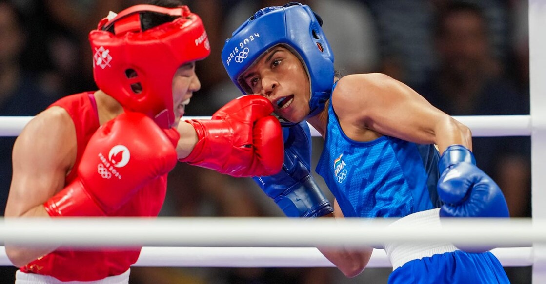 Wu Yu  lands a punch on Nikhat Zareen. Photo: PTI/Ravi Choudhary