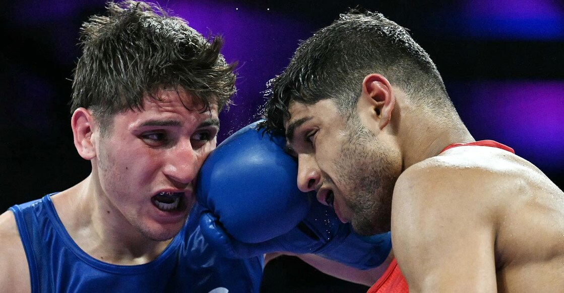 Marco Verde Alvarez  lands a punch on Nishant Dev. Photo: AFP/Mohd Rasfan