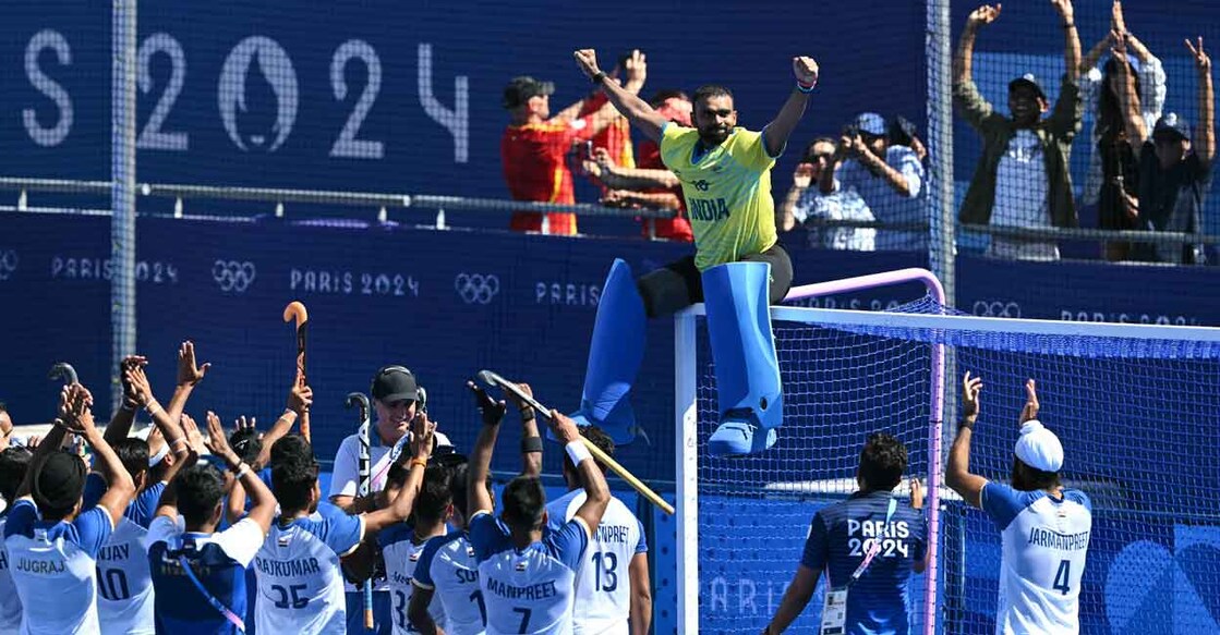 Goalkeeper P R Sreejesh is cheered by teammates and fans after India won the bronze medal in hockey at Paris 2024 Olympics at the Yves-du-Manoir Stadium in Colombes on August 8, 2024. Photo: AFP/ Arun Sankar