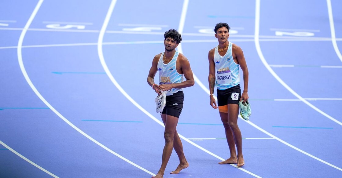 Amoj Jacob and Rajesh Ramesh react after the race. Photo: PTI /Ravi Choudhary