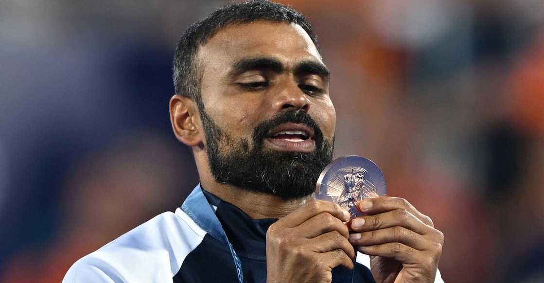 Sreejesh celebrates on the podium with the bronze medal. Photo: AFP/Arun Sankar