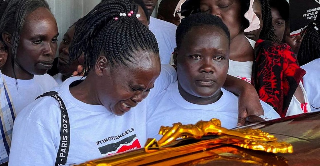 Agnes Cheptegei mourns next to the coffin of her daughter Rebecca Cheptegei. Photo: Reuters/Edwin Waita