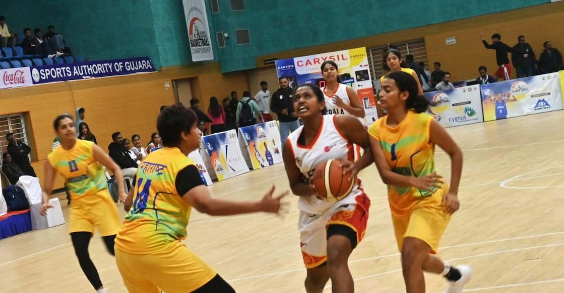 The senior national basketball championship quarterfinal match between Kerala (white) and Maharashtra was held in Gujarat on Friday. Photo: Special arrangement