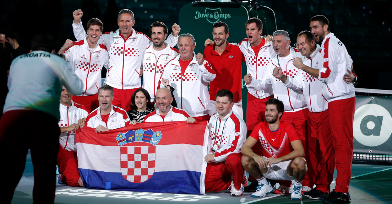 Croatian players and support staff celebrate the win. Photo: Reuters/Guglielmo Mangiapane
