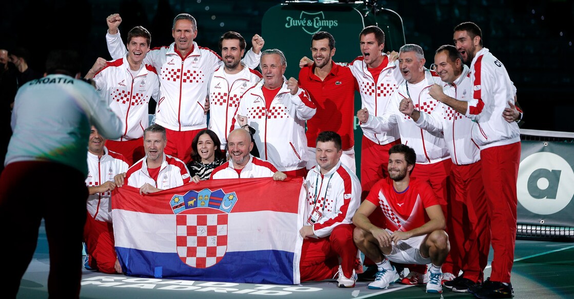 Croatian players and support staff celebrate the win. Photo: Reuters/Guglielmo Mangiapane