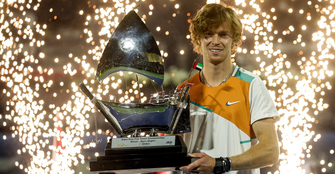 Andrey Rublev poses with the winner's trophy. Photo: AFP/Karim Sahib