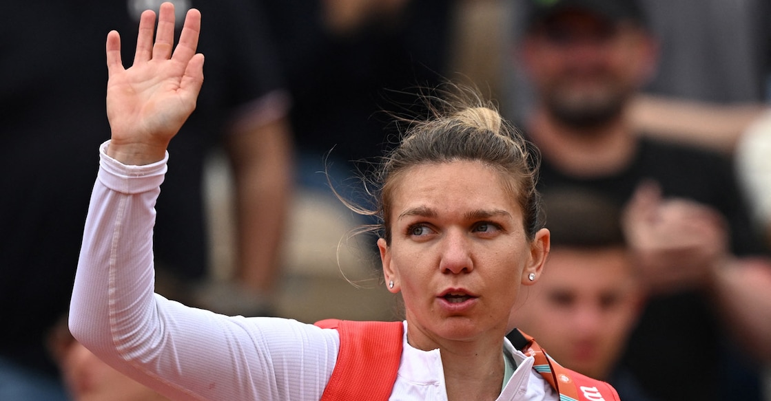 Simona Halep acknowledges the spectators after losing her second round match to Zheng Qinwen. Photo: Reuters/Dylan Martinez