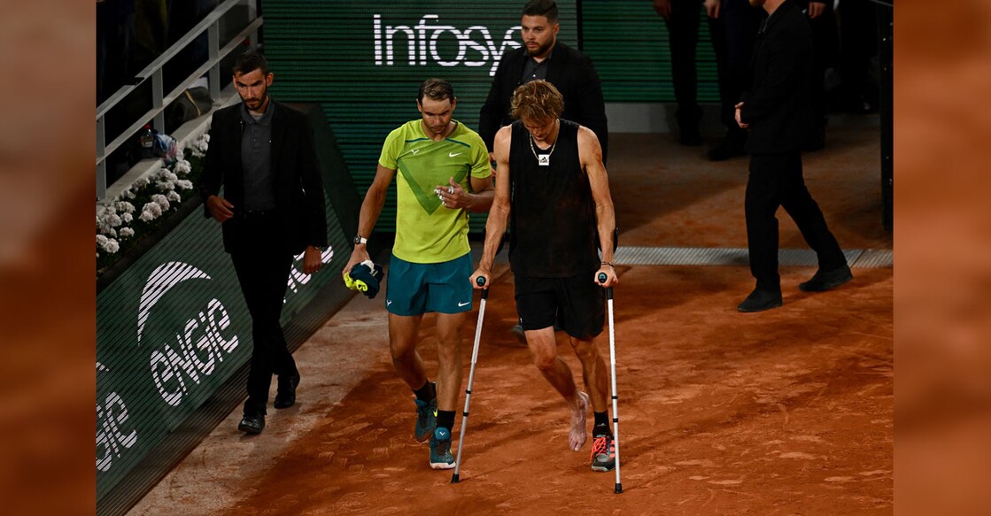 Germany's Alexander Zverev (right) walks with crutches on the court after being injured during his men's semifinal against Spain's Rafael Nadal at the Court Philippe-Chatrier in Paris on Friday. Photo: AFP/ Anne-Christine Poujoulat