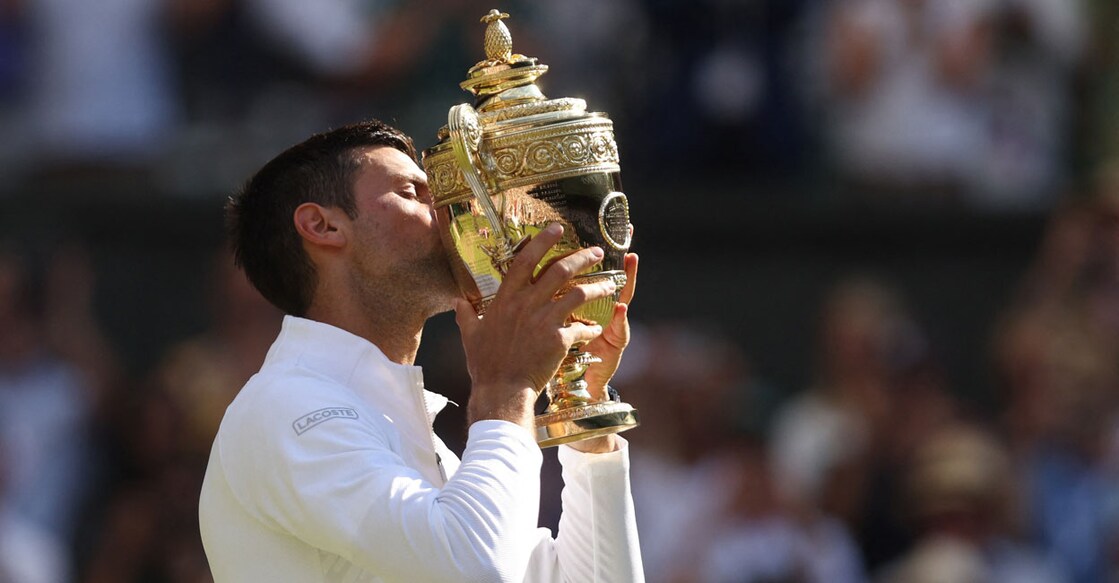 Serbia's Novak Djokovic celebrates with the trophy after winning the men's singles final against Australia's Nick Kyrgios. Photo: Reuters/ Matthew Childs