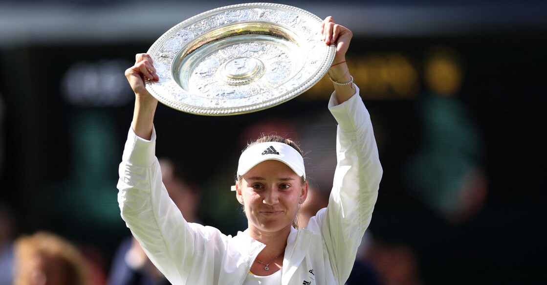 Kazakhstan's Elena Rybakina celebrates with the trophy after winning the women's singles final against Tunisia's Ons Jabeur. Photo: Reuters/ Matthew Childs