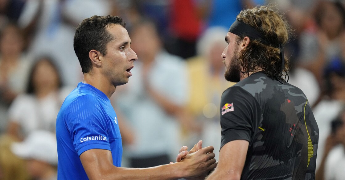 Daniel Elahi Galan of Colombia, left, and Stefanos Tsitsipas of Greece shake hands after their first round match on day one of the 2022 U.S. Open tennis tournament at USTA Billie Jean King National Tennis Center. Photo: Jerry Lai-USA TODAY Sports via Reuters