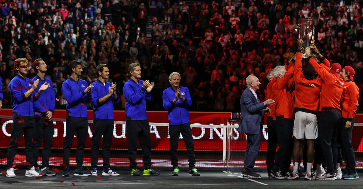 TENNIS-ATP-LAVER-GBR Team Europe players (left) and Rod Laver (centre) applaud as Team World players as they lift the 2022 Laver Cup at the O2 Arena in London on Sunday. Photo: AFP/ Adrian Dennis