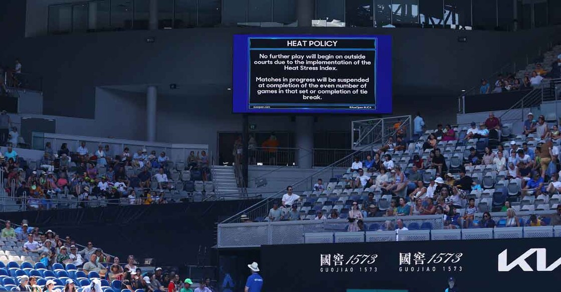 Heat policy message displayed on the big screen as play is suspended on the outside courts due to high temperatures. Photo: Reuters/Carl Recine