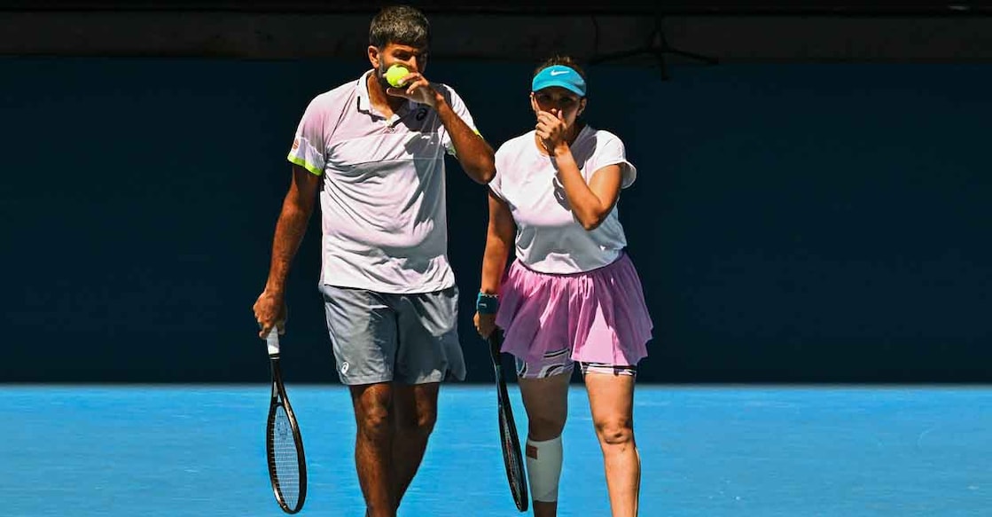 Rohan Bopanna and Sania Mirza speak before a point during the mixed doubles final. Photo: AFP/Anthony Wallace