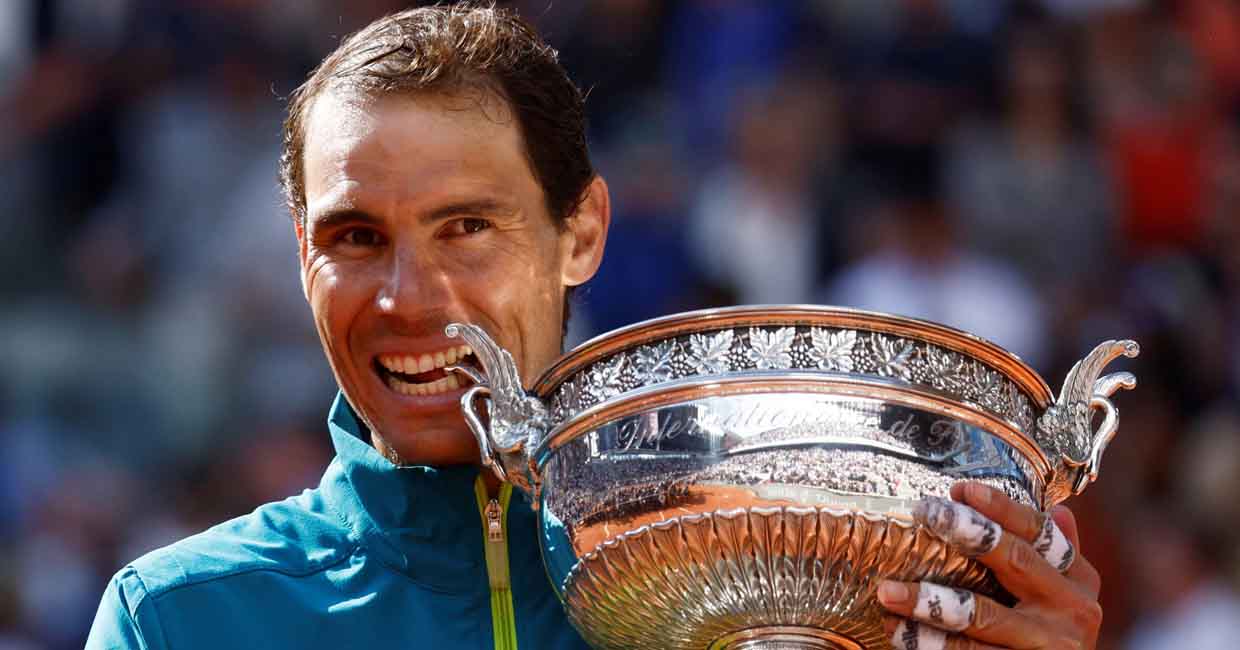 FILE PHOTO: Tennis - French Open - Roland Garros, Paris, France - June 5, 2022 Spain's Rafael Nadal bites the trophy to celebrate winning the men's singles final against Norway's Casper Ruud REUTERS/Yves Herman/File Photo