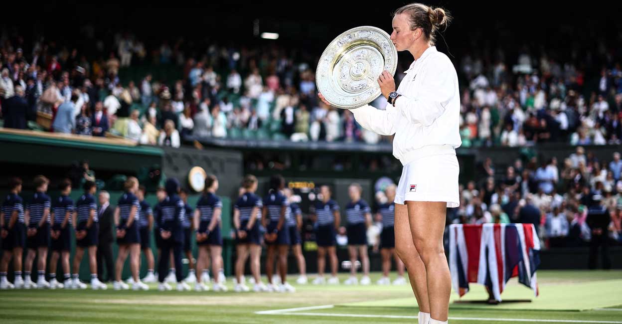Czech Republic's Barbora Krejcikova kisses the winner's trophy, the Venus Rosewater Dish, after winning against Italy's Jasmine Paolini during their women's singles final tennis match on the thirteenth day of the 2024 Wimbledon Championships at The All England Lawn Tennis and Croquet Club in Wimbledon, southwest London, on July 13, 2024. - Krejcikova won the match 6-2, 2-6, 6-4. (Photo by HENRY NICHOLLS / AFP) / RESTRICTED TO EDITORIAL USE