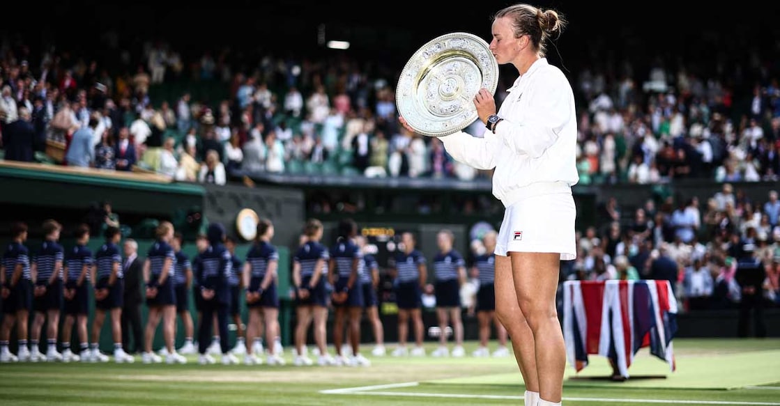 Czech Republic's Barbora Krejcikova kisses the winner's trophy, the Venus Rosewater Dish, after winning against Italy's Jasmine Paolini during their women's singles final tennis match on the thirteenth day of the 2024 Wimbledon Championships at The All England Lawn Tennis and Croquet Club in Wimbledon, southwest London, on July 13, 2024. - Krejcikova won the match 6-2, 2-6, 6-4. (Photo by HENRY NICHOLLS / AFP) / RESTRICTED TO EDITORIAL USE